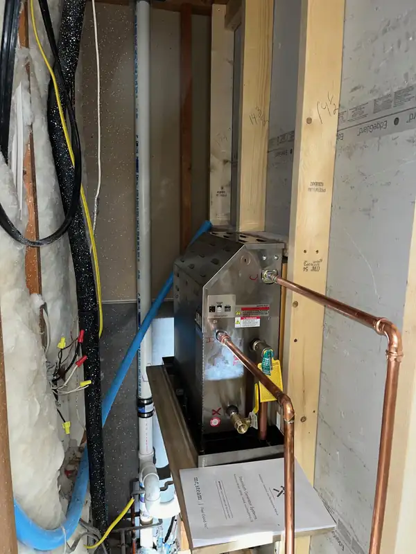 New copper water lines run neatly through an open wall cavity